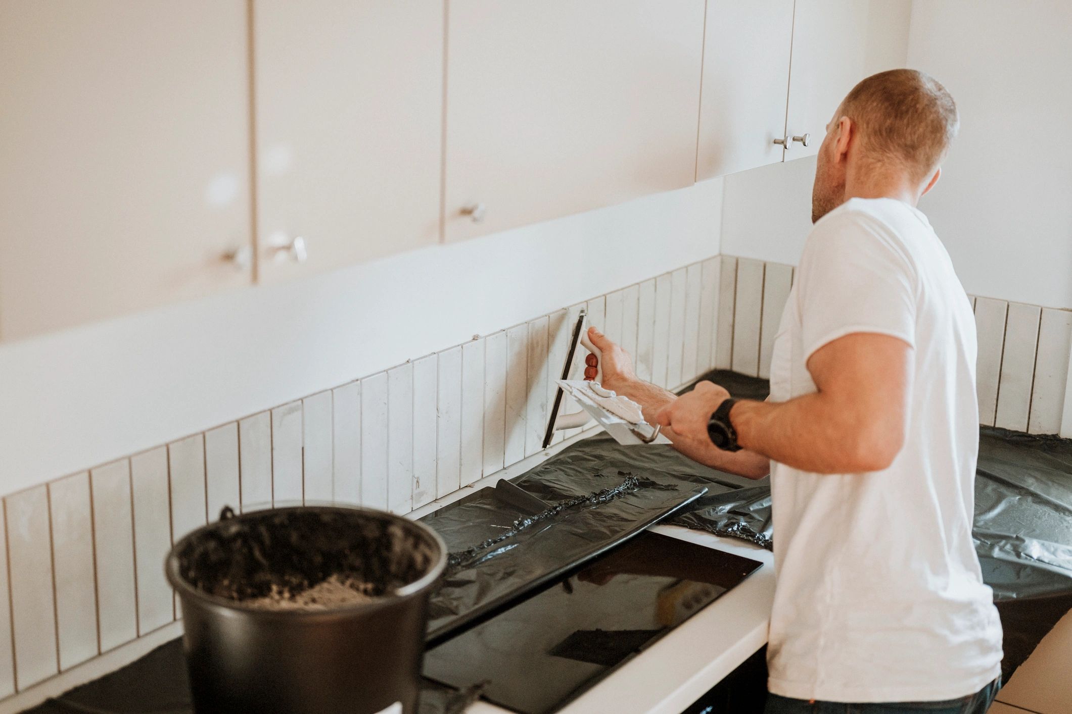 Installer placing kitchen backsplash tile